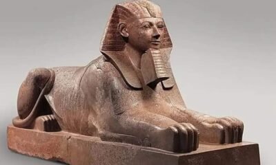 Colossal granite statue of Hatshepsut portrayed as a muscular male king, wearing a false beard and kilt, emphasizing her royal transformation.