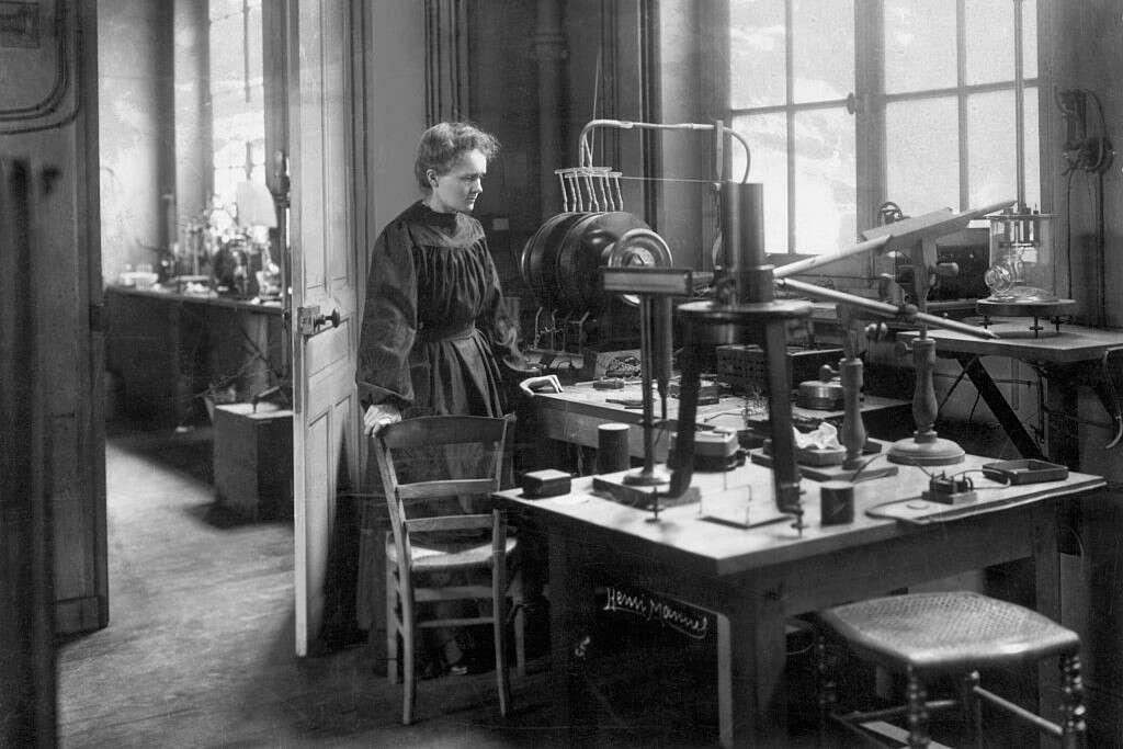 Marie Curie, famous female scientist, working with radioactive materials in her groundbreaking laboratory.